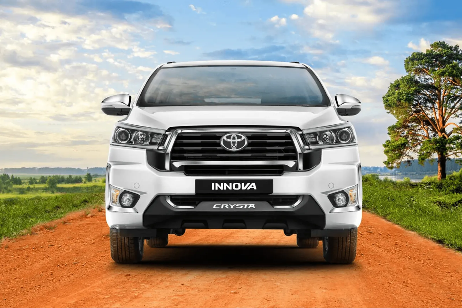 White Toyota Innova Crysta front view on an open country road – Innova Crysta car rental Chennai with driver