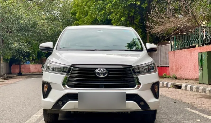 White Toyota Innova Crysta front view with chrome grille, available for rent in Chennai