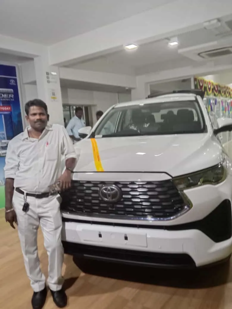 Sri Meenakshi Travels driver taking delivery of a new Innova Hycross at a Toyota showroom