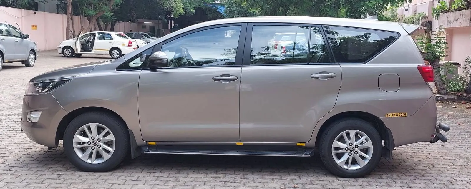Silver Toyota Innova Crysta side view showing the 7-seater cabin length
