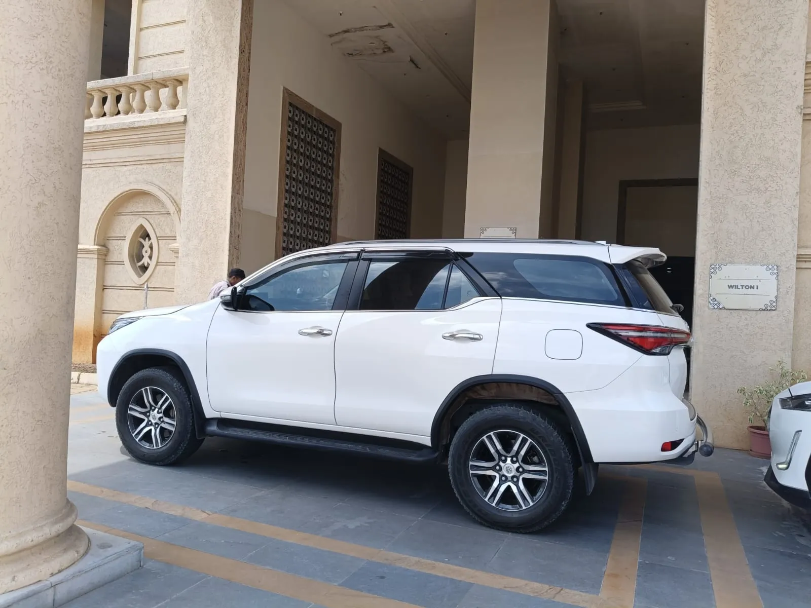 White Toyota Fortuner waiting at a hotel porch for a VIP pickup in Chennai